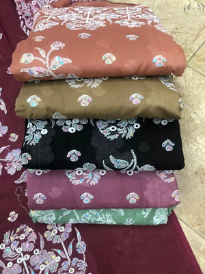 Stack of folded fabric with floral patterns on a textured surface