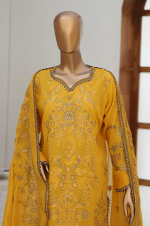 Yellow embroidered traditional outfit on a mannequin against a neutral background