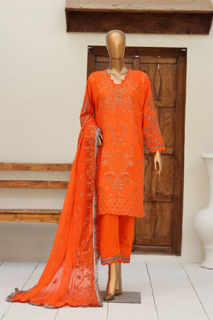 Orange embroidered outfit on a mannequin against a white wall with wooden steps.