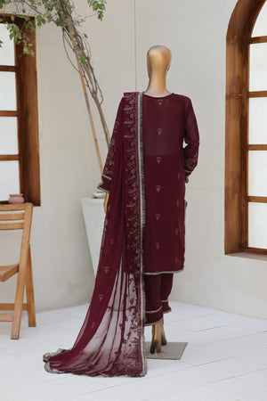 Maroon traditional outfit with a sheer dupatta on a mannequin against a neutral background.