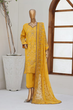 Yellow embroidered traditional outfit on a mannequin against a white wall with a wooden window frame.